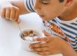 boy eating yoghurt and cereals